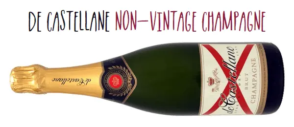 Bottle of de Castellane non-vintage Champagne on its side with its distinctive red cross on the label