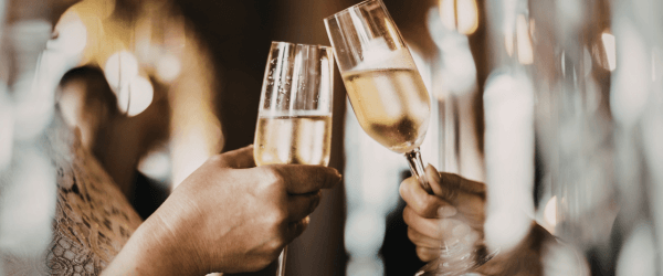 Two glasses of vintage champagne touching as a Cheers!