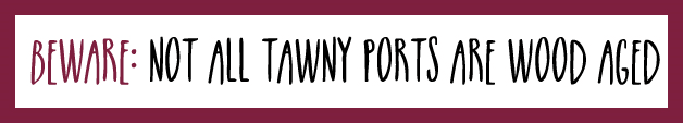 A sign with burgundy coloured edging saying "beware not all tawny ports are wood aged"