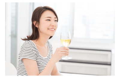 Woman enjoying a glass of white wine
