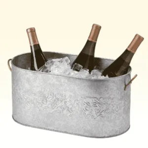 Three bottles of wine chilling in ice in a silver wine trough