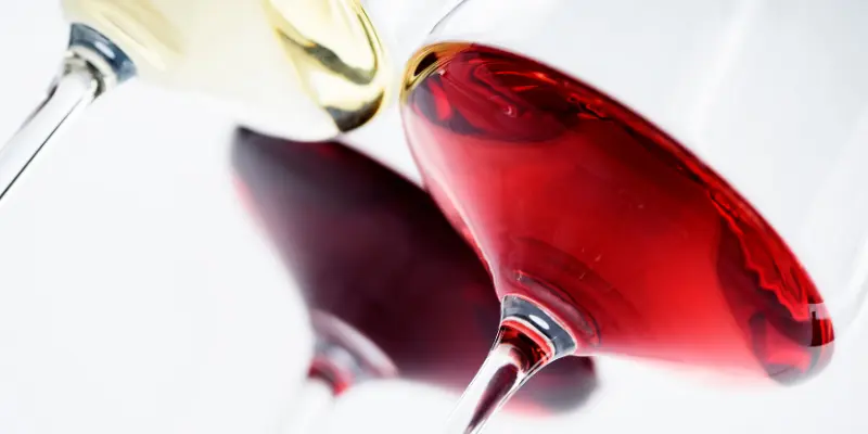 Three glasses of wine, one red, one rosé and one white