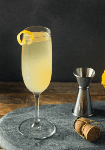 Glass of French 75 cocktail, lemon sugar syrup and champagne