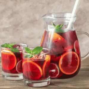 Glass jug and two glasses of red wine sangria