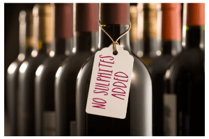 Bottles of red wine on with a tag around its neck reading "No sulphites added"