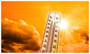 Thermometer in bright sunshine showing high temperature