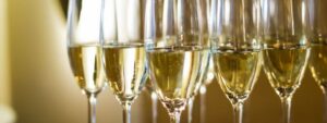 A number of glasses containing sparkling wine
