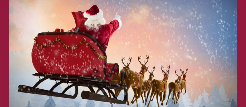 Santa on his sleigh being pulled by reindeer