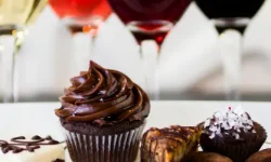 A selection of small chocolate desserts with glasses of different wines
