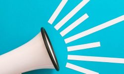 Red & white megaphone against a bright blue background